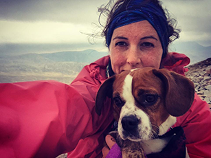 Lady smiling holding dog