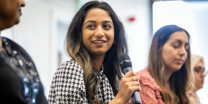 A woman speaking into a microphone