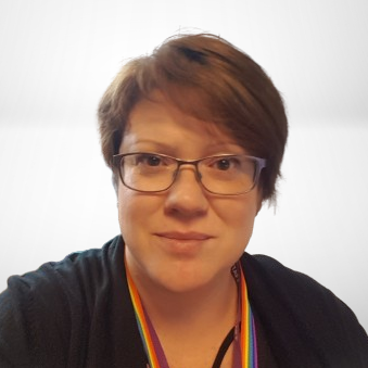 Abigail Mason looking towards camera. Wearing a black top and the background is white.