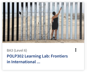 A lady in a black dress is painting a black fence white.