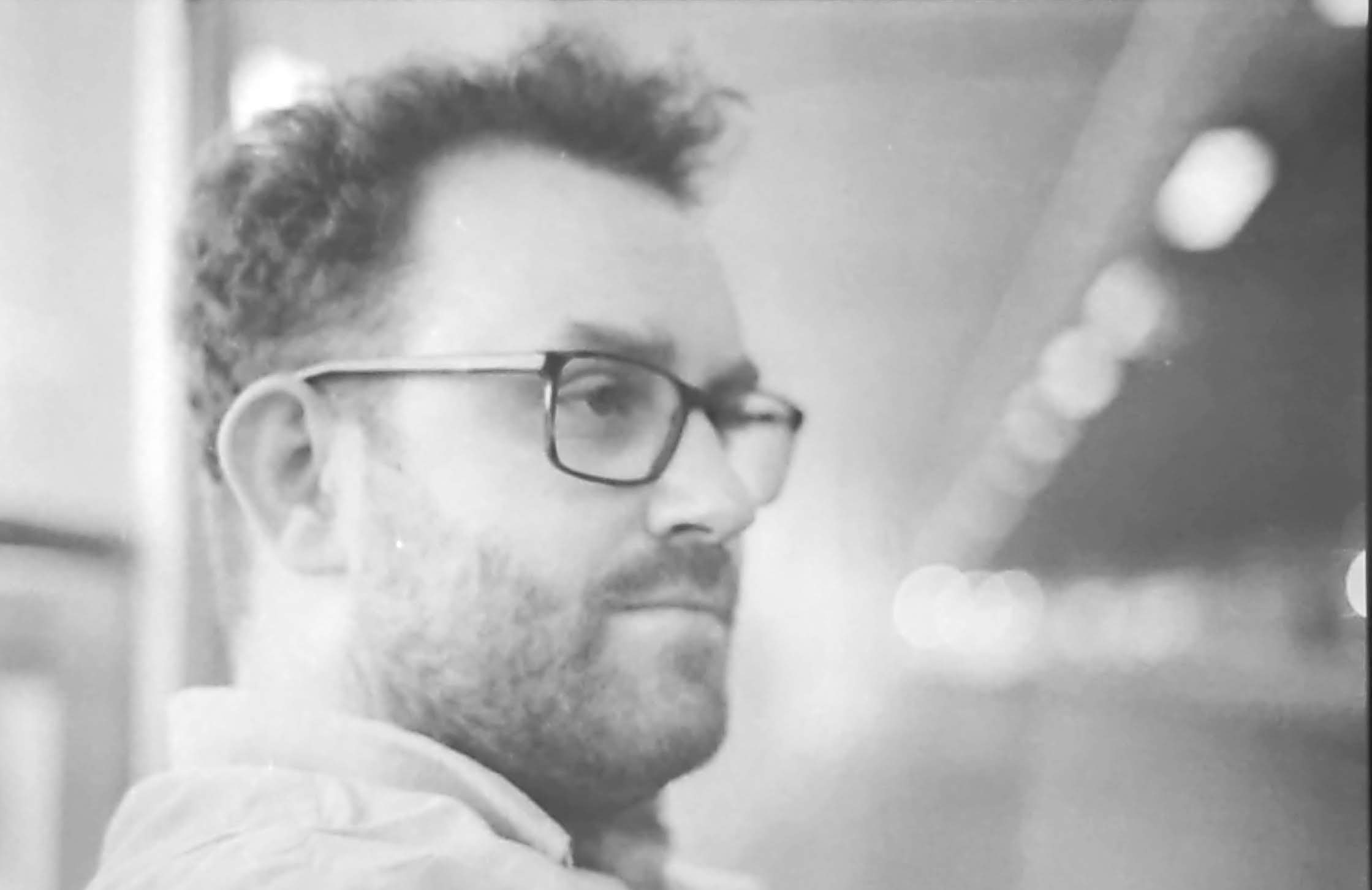 Thomas Hinks profile photo in black and white. Thomas is looking to the right.