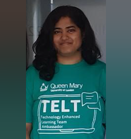 Yashasvi Nancherla in a green TELT ambassador t-shirt. Looking at the camera in front of a white wall..
