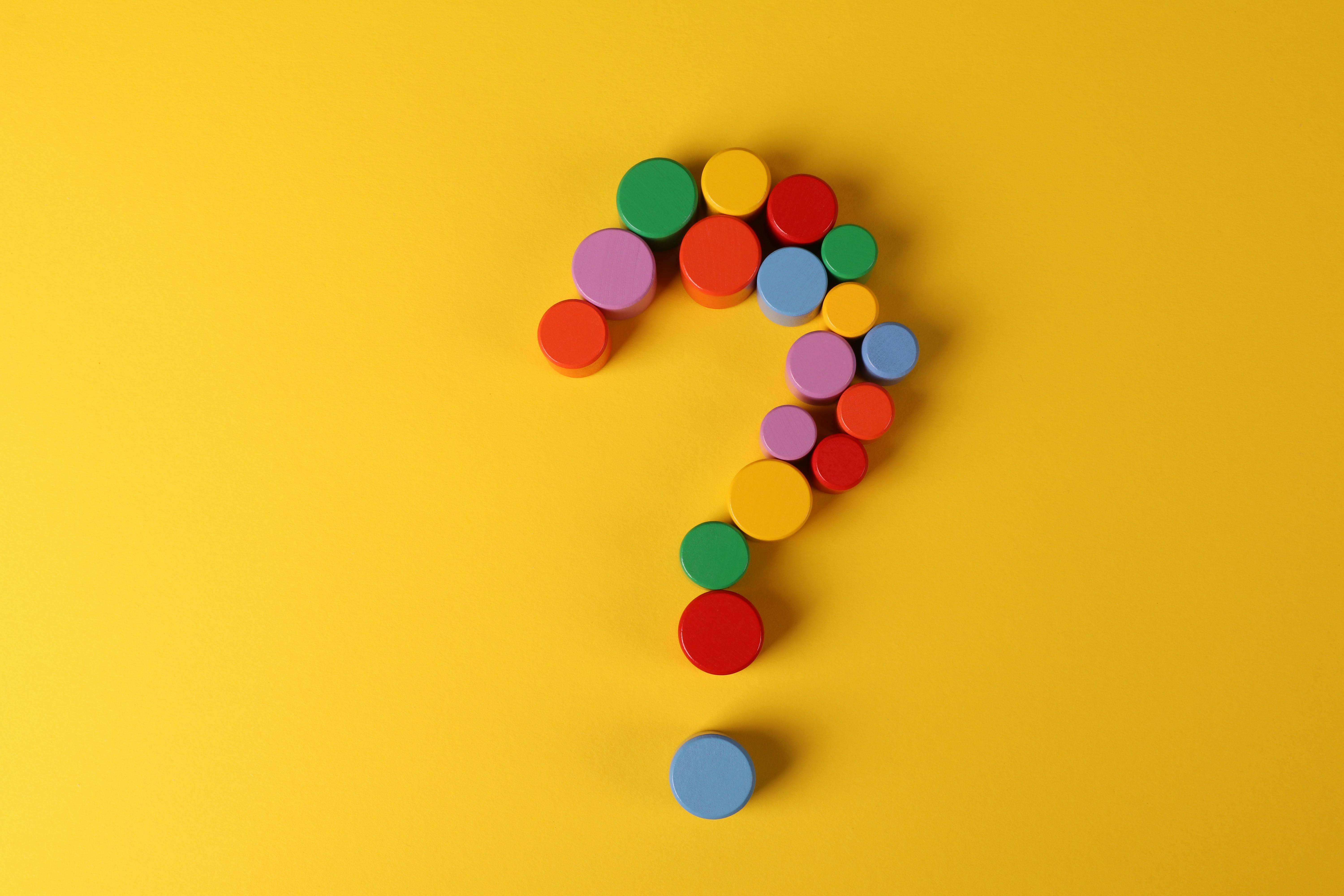 question mark multicoloured formed of small circles with a yellow background