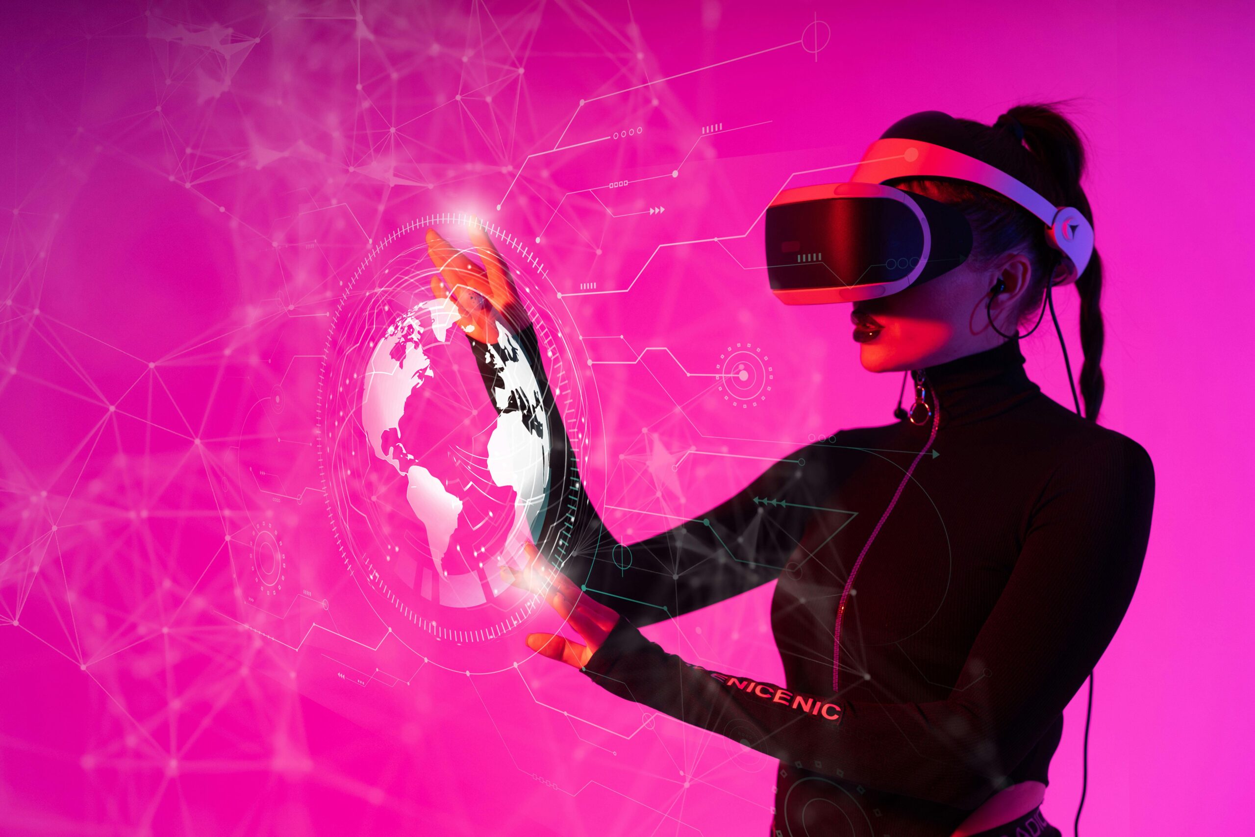 A lady wearing a VR headset with an outline of earth in their hands. They is a pink background and the person is wearing black.
