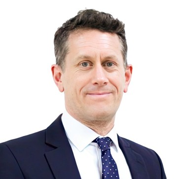 Chris Southworth wearing a suit and tie.