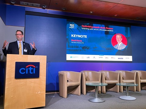 Neal Harm speaking on stage at the conference.