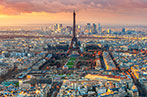 The skyline of Paris with the Eiffel Tower at the forefront and the skyscrapers of La Défense in the background.