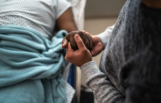 Patient holding hand