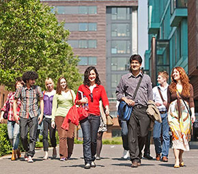 Customers walking outside France House at Stay QM with Pooley House in the background.